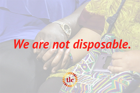 Two people hold hands with the text "We are not disposable" overlaid